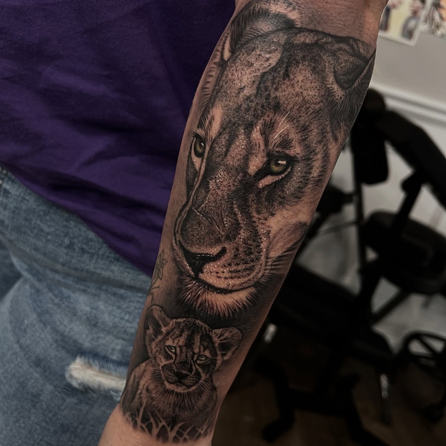 Black and grey realism lioness and cub forearm tattoo by Nicholas Tattoo, Camden NSW