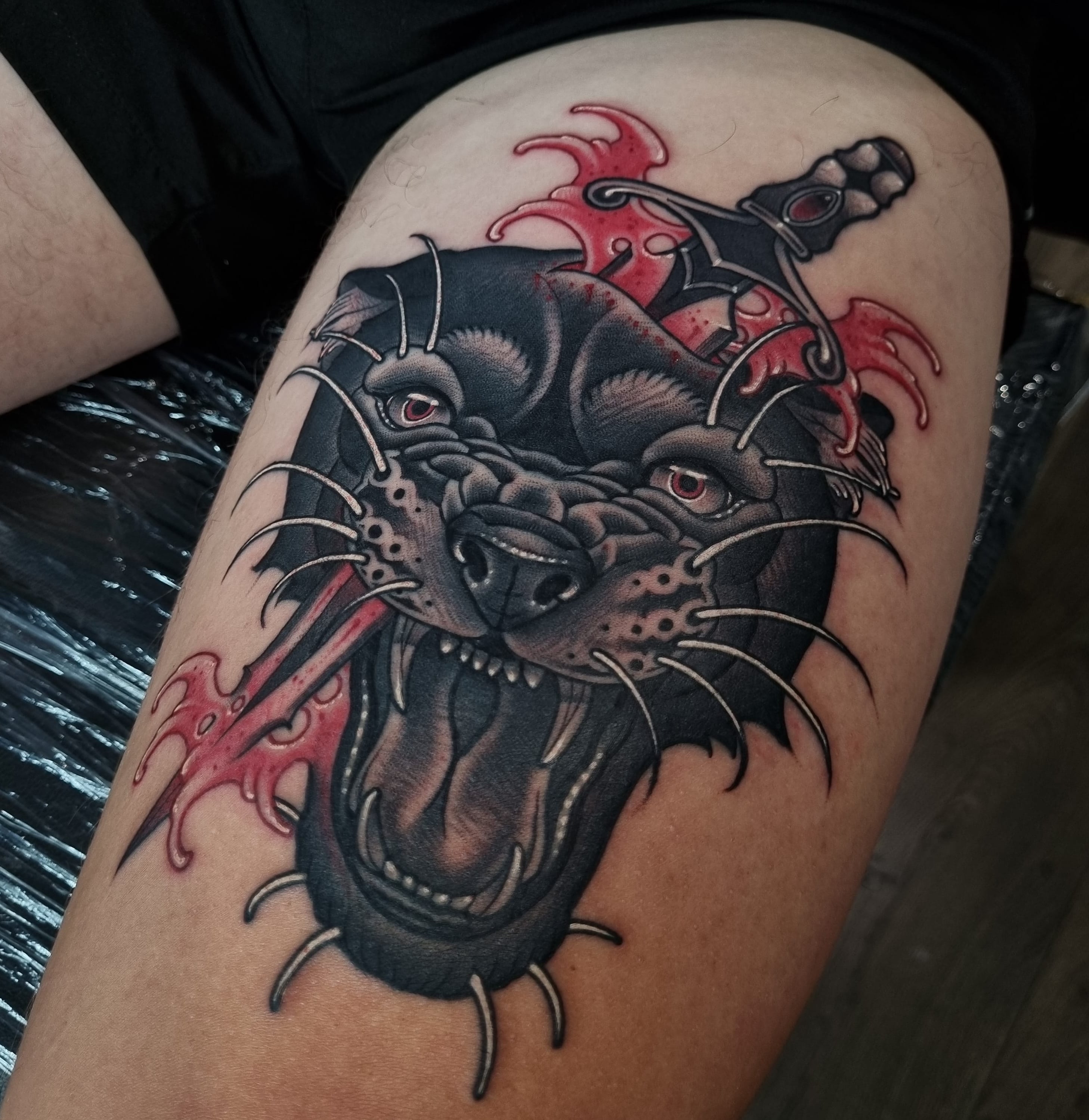 Neo-traditional panther and dagger thigh tattoo by Nicholas Tattoo, Camden NSW