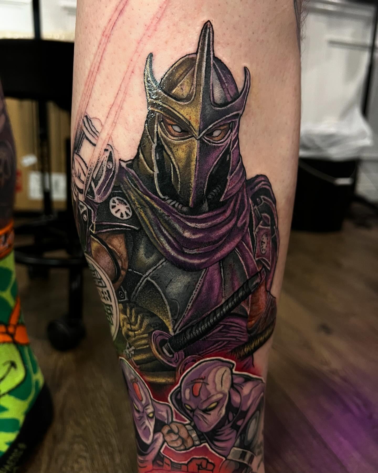 Colour cartoon TMNT Shredder leg sleeve tattoo by Nicholas Tattoo, Camden NSW