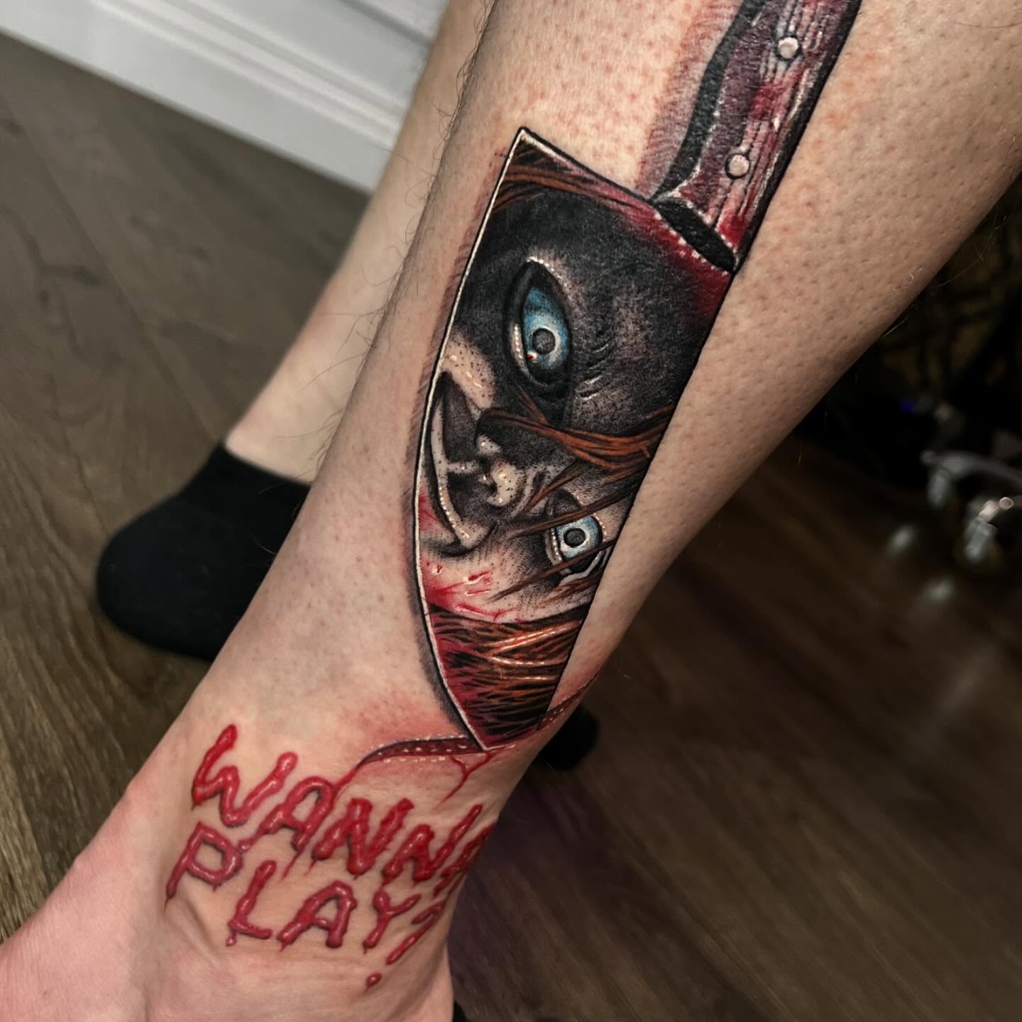 Colour horror Chucky with knife reflection tattoo by Nicholas Tattoo, Camden NSW